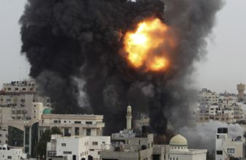 An Israeli air strike in the Gaza Strip 370 (R) (photo credit: Suhaib Salem / Reuters)