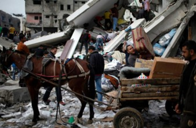 Horse drawn buggy in Gaza amid wreckage and destruction 370 (photo credit: Reuters/Ahmed Jadallah)