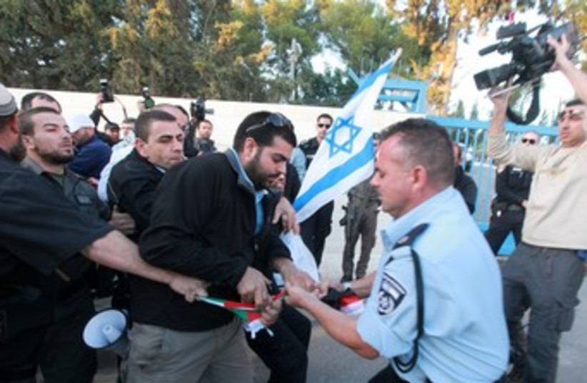 Police snatch flag from protester who tried to burn it 370 (photo credit: Marc Israel Sellem/The Jerusalem Post)