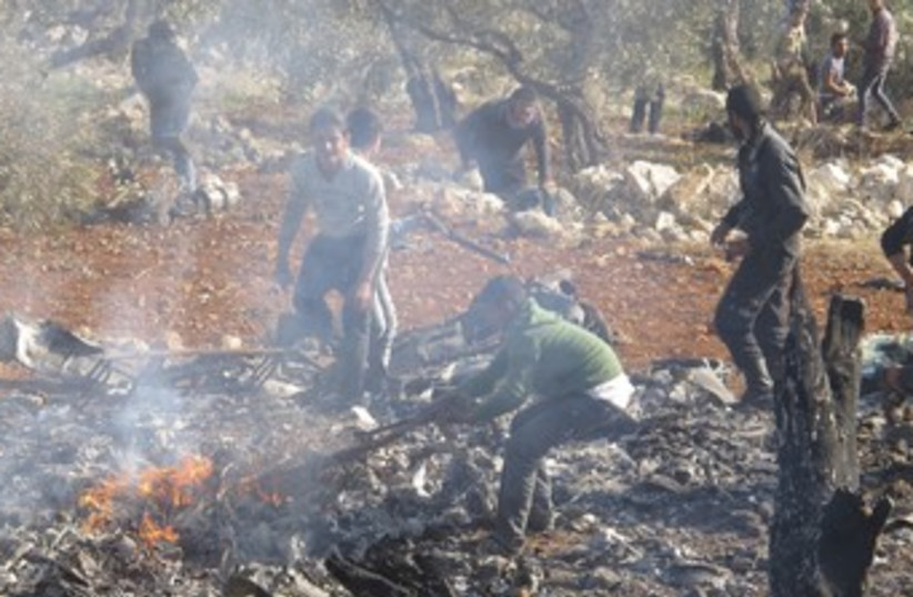 Burning wreckage of  Syrian warplane 370 (photo credit: REUTERS/Abdalghne Karoof)