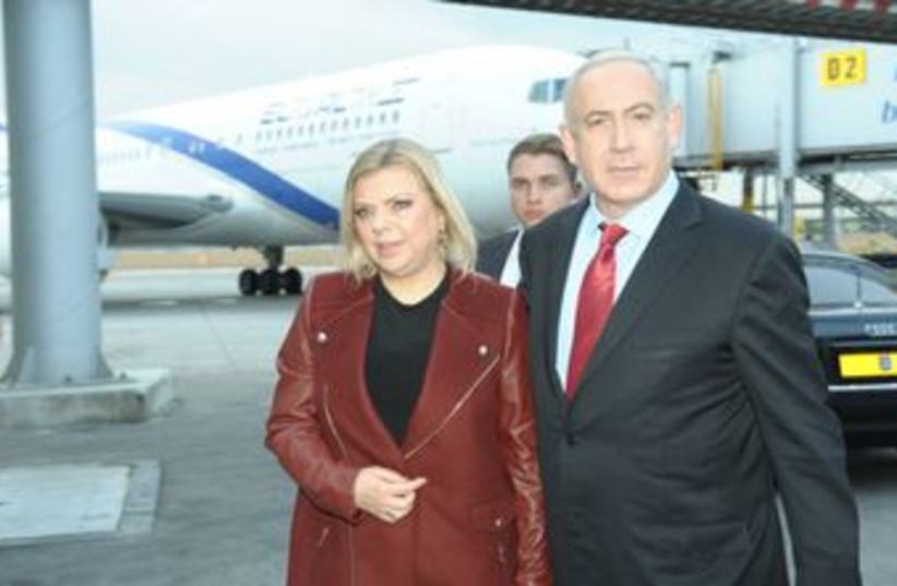 PM Netanyahu departs from B-G Airport with wife Sarah 370 (photo credit: GPO / Amos Ben-Gershom)
