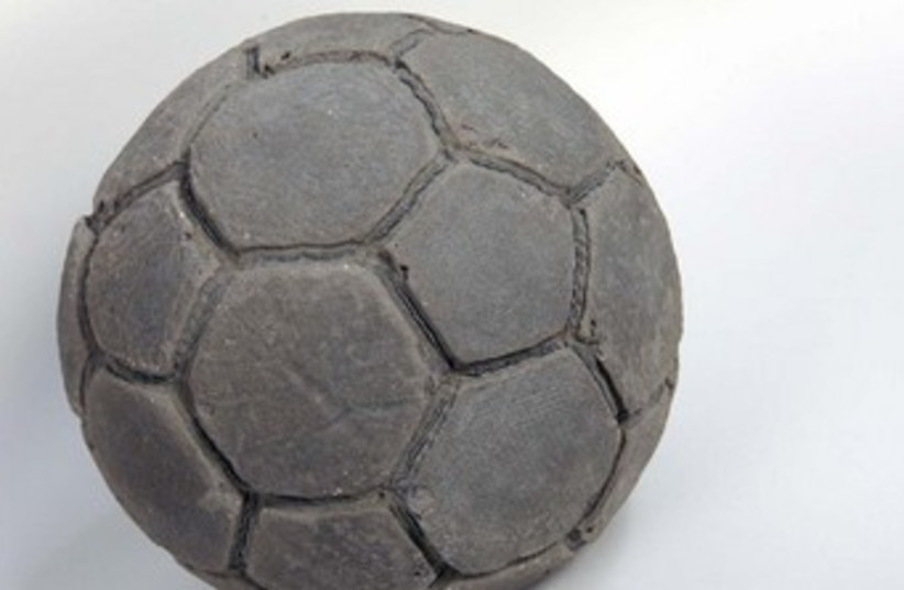 Khaled Jarrar with his concrete soccer ball 370 (photo credit: The Media Line)
