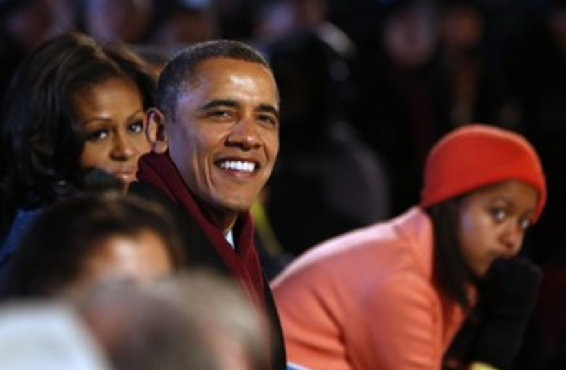 Obama and family in wintery clothing VOGUE 370 (photo credit: REUTERS/Larry Downing)
