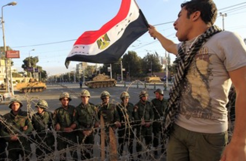 Egypt Revolution Part II Dec 2012 man with flag - 370 (photo credit: REUTERS)