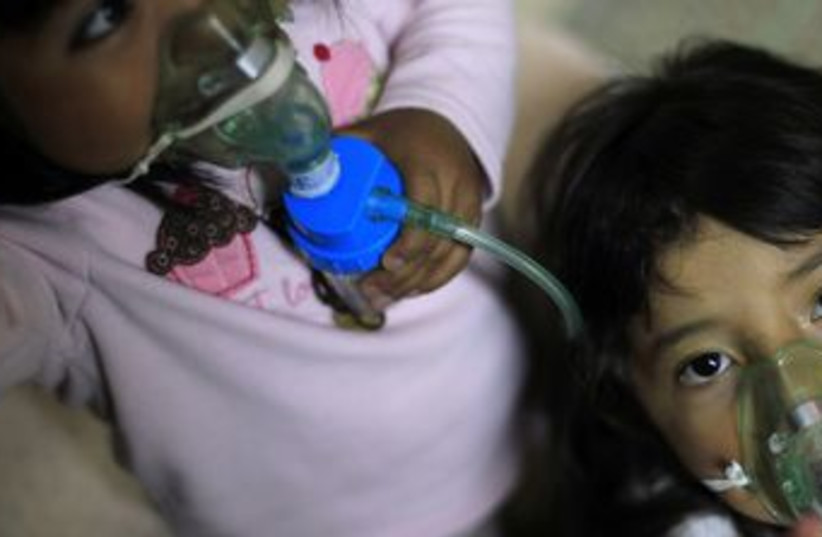 Children receiving medical treatment in hospital 370 (R) (photo credit: Jorge Lopez / Reuters)