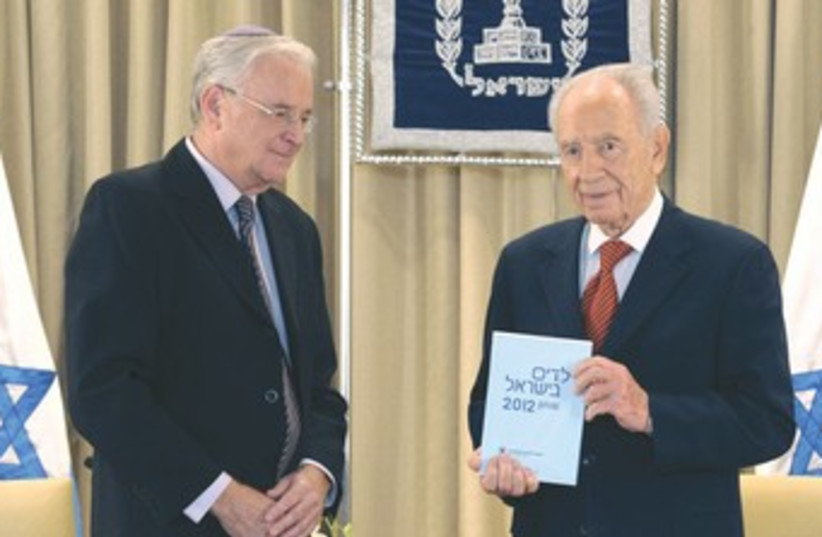 Peres with Poverty Report 370 (photo credit: President’s Residence)
