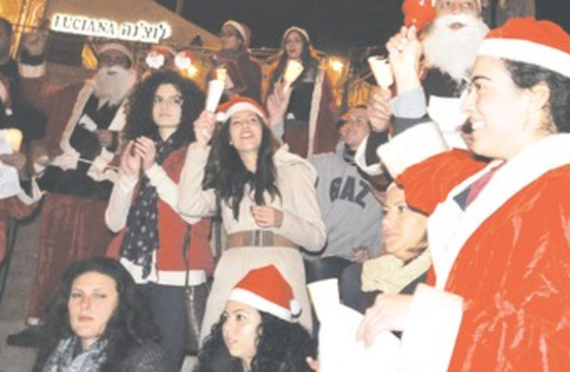 Celebrants dressed as Santa at J'lem's Mamilla Mall 370 (photo credit: Sarah Levin)
