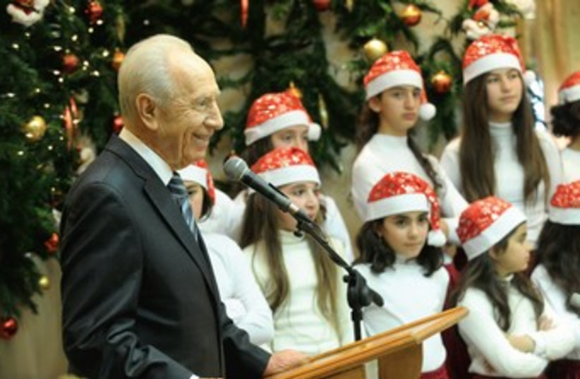 Peres celebrates Christmas with Christian-Arab school kids (photo credit: Mark Neiman/GPO)
