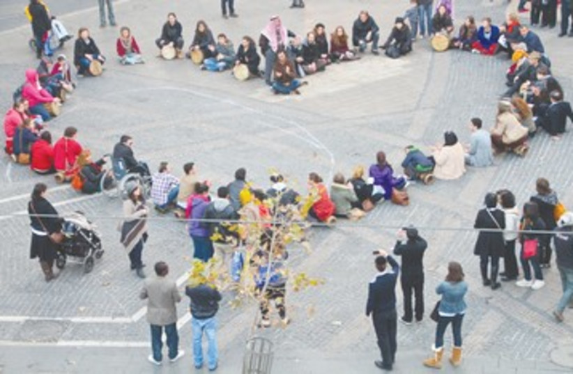 Peace activists in heart-shaped drum circle 390 (photo credit: TOVAH LAZAROFF)