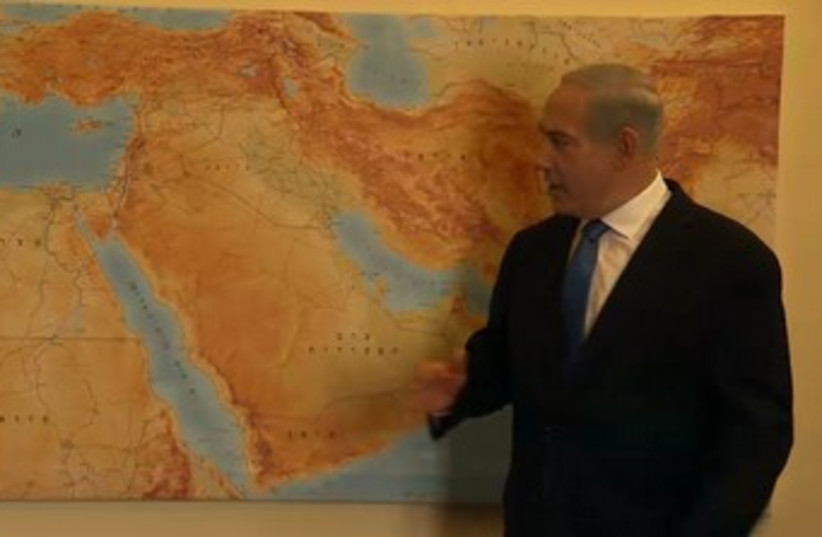 PM points to map in Likud Beytenu campaign video 370 (photo credit: Screenshot)