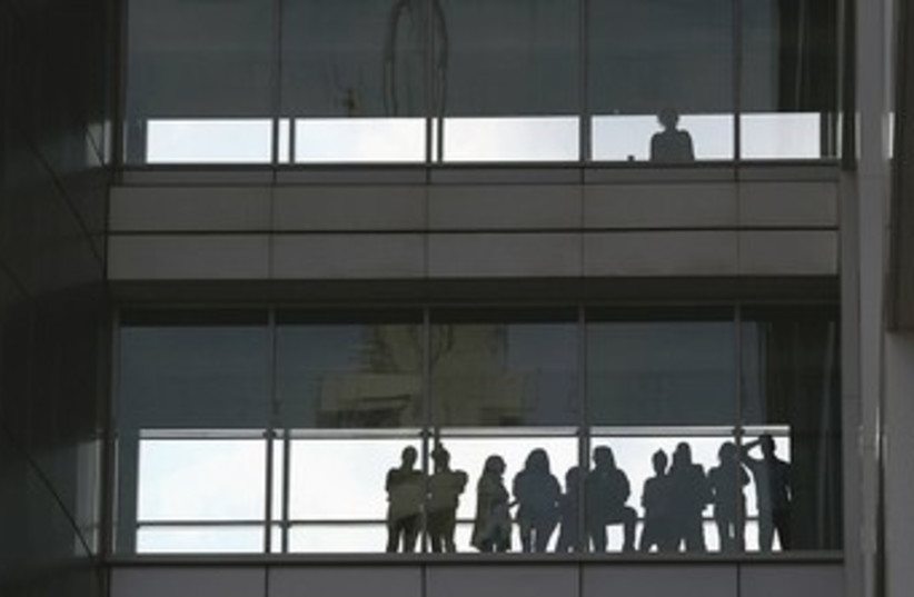 Workers at the Defense Ministry in Tel Aviv 370 (R) (photo credit: Pool / Reuters)