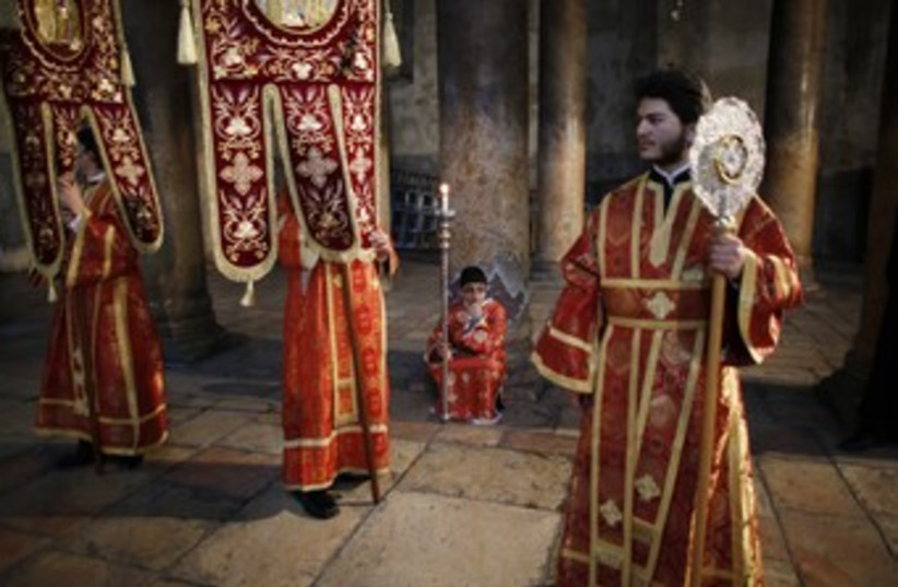 Members of the Greek Orthodox clergy and altar servers 370 (photo credit: Reuters/Ammar Awad)
