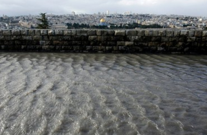 Rain water creates floods and puddles in Jerusalem (photo credit: Reuters/Ammar Awad)