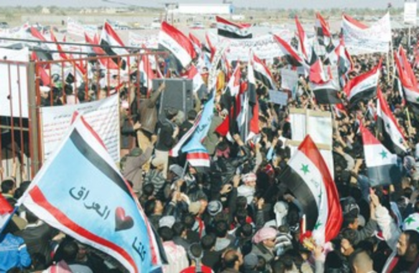 IRAQI SUNNIS wave national flags 370 (photo credit: Ali al-Mashhadani/Reuters)