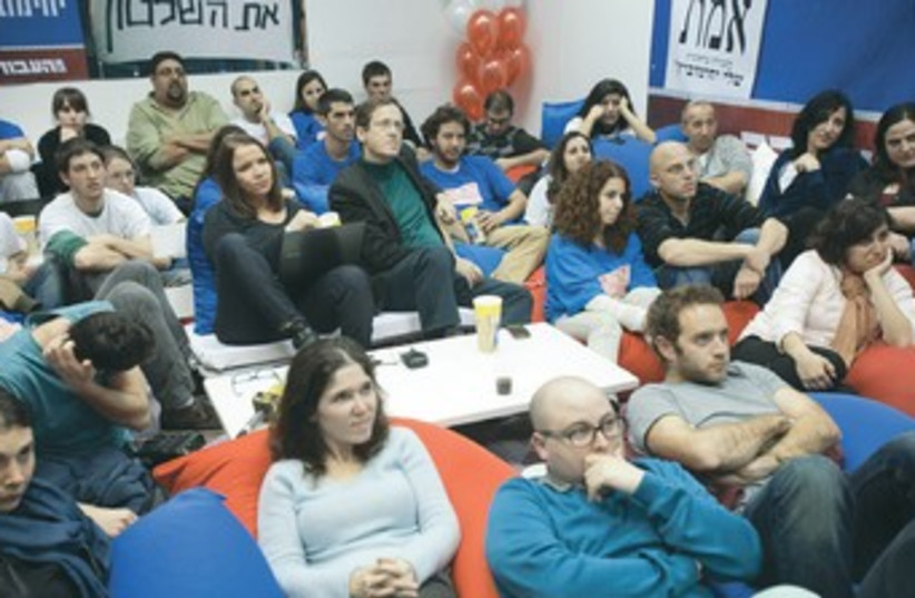 Labor party supporters watch election ads 370 (photo credit: Shai Skiff)
