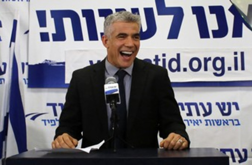 Yair Lapid addressing supporters in post election speech 370 (photo credit: REUTERS/Ammar Awad)