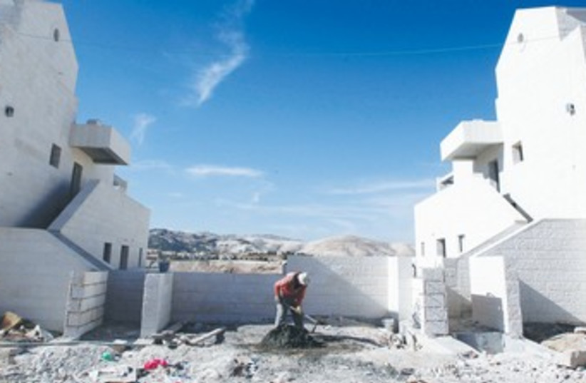 PALESTINIAN builds a home in Ma’aleh Adumim 370 (photo credit: REUTERS/Marcos Brindicci )
