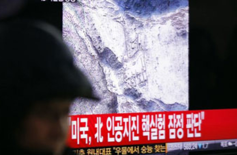 Seoul man watches North Korea test (photo credit: Reuters)
