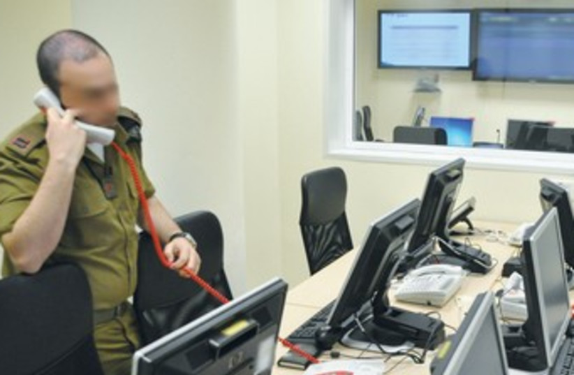 IDF officer on phone, computers 370 (photo credit: IDF Spokesman’s Office)