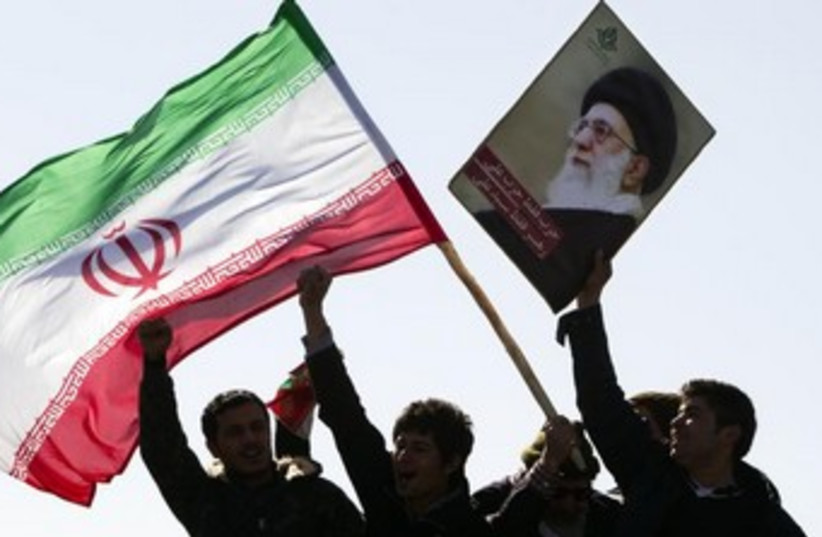 Demonstrators wave Iran's flag  (photo credit: REUTERS/Raheb Homavandi)