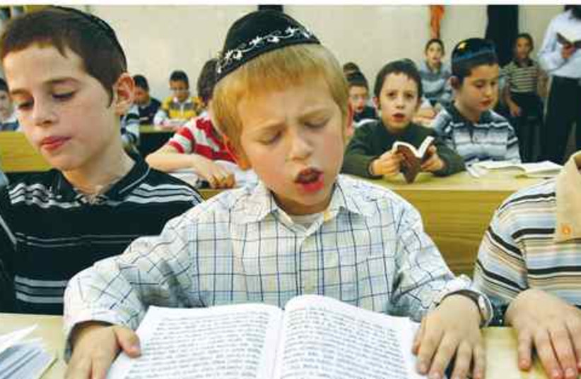 Jewish boy reads 521 (photo credit: GIL COHEN MAGEN/REUTERS)