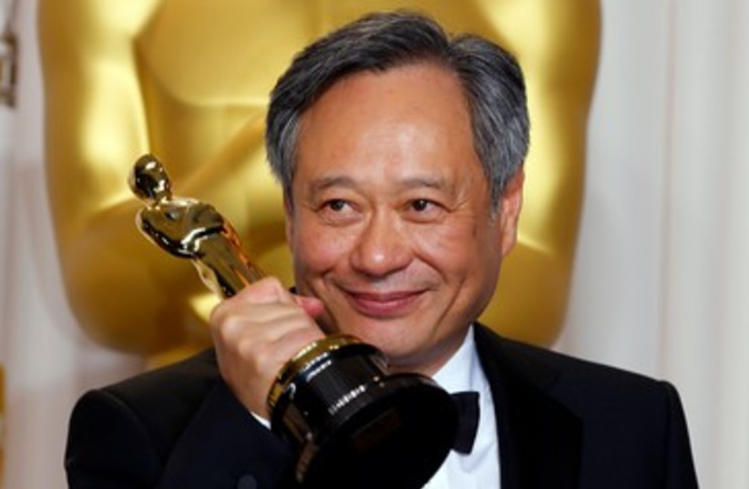 Director Ang Lee poses with his Oscar for Best Director  (photo credit: REUTERS/ Mike Blake)