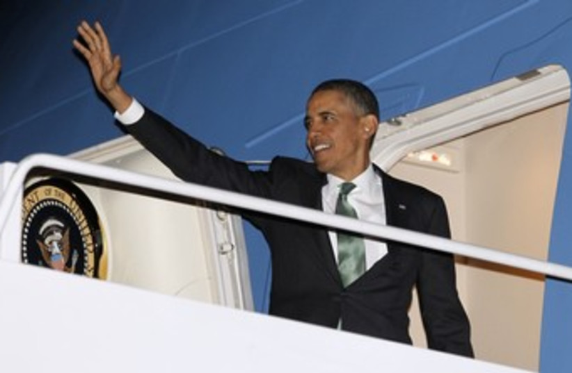 Obama waves as he steps aboard Air Force One 370 (photo credit: REUTERS)