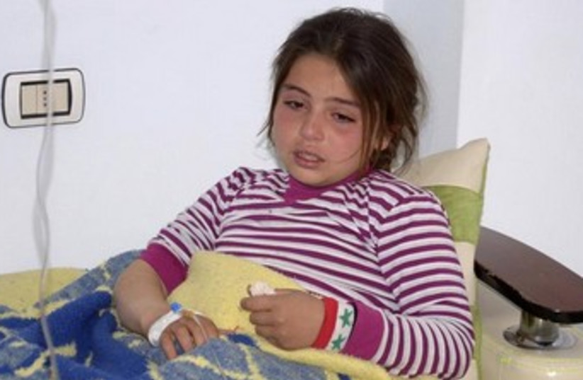 Girl allegedly hurt in Syria chemical weapon attack 370 (photo credit: REUTERS/George Ourfalian)