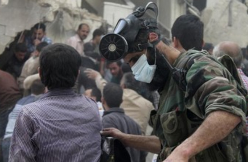 Syrian man with gas mask 370 (photo credit: REUTERS/Haleem Al-Halabi)