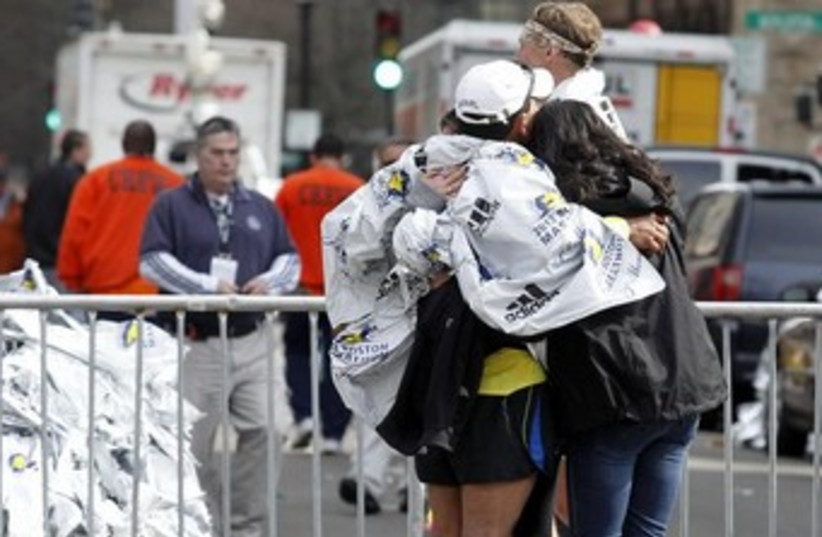 People comforting each other after Boston blast 370 (photo credit: REUTERS/Jessica Rinaldi)