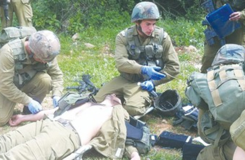 Lt Gilad Spiegel treats a patient 370 (photo credit: IDF Spokesman’s Office))