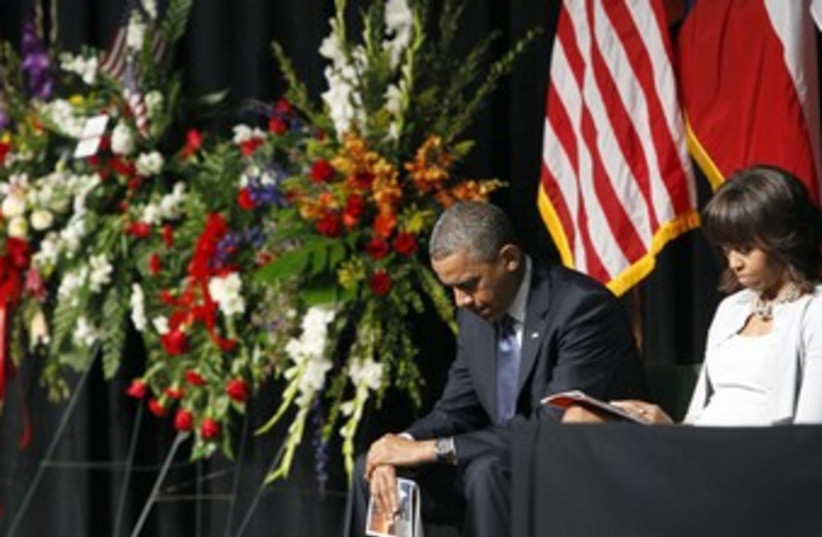 Obama and first lady in mourning 370 (photo credit: REUTERS)