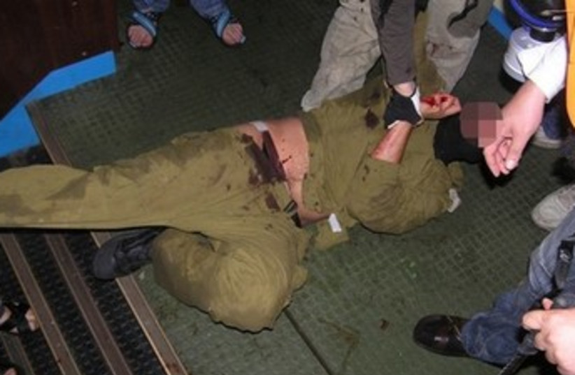 Israeli soldier attacked by Mavi Marmara passengers 370 (photo credit: REUTERS)