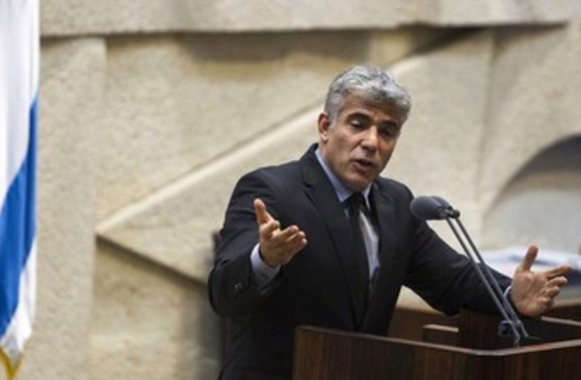 Lapid addressing the knesset 370 (photo credit: REUTERS)
