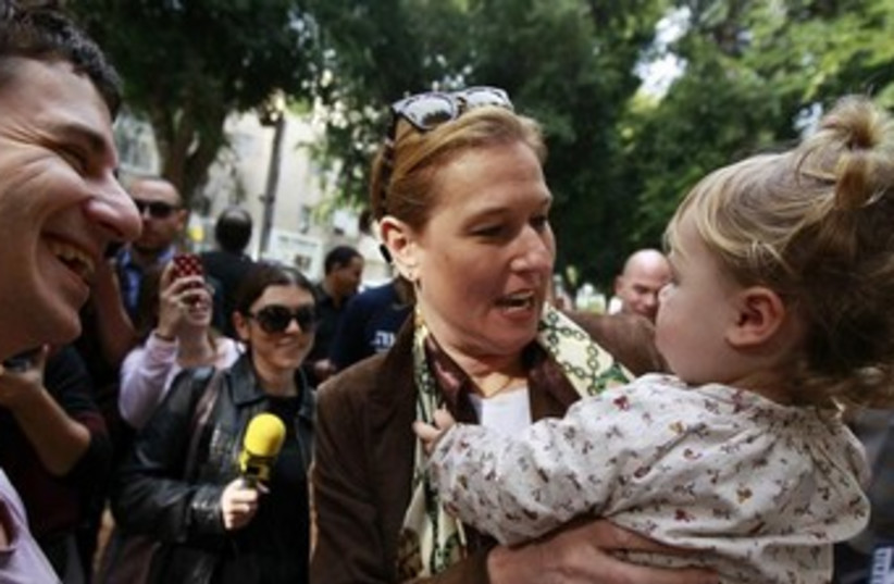 Livni holds a baby 370 (photo credit: REUTERS)