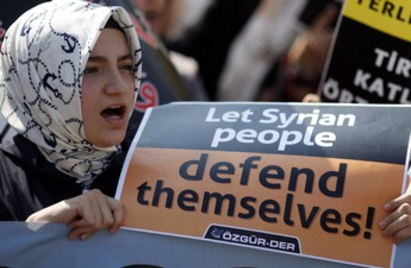 Woman shouts slogans during protest against Assad 370 (photo credit: REUTERS/Osman Orsal)