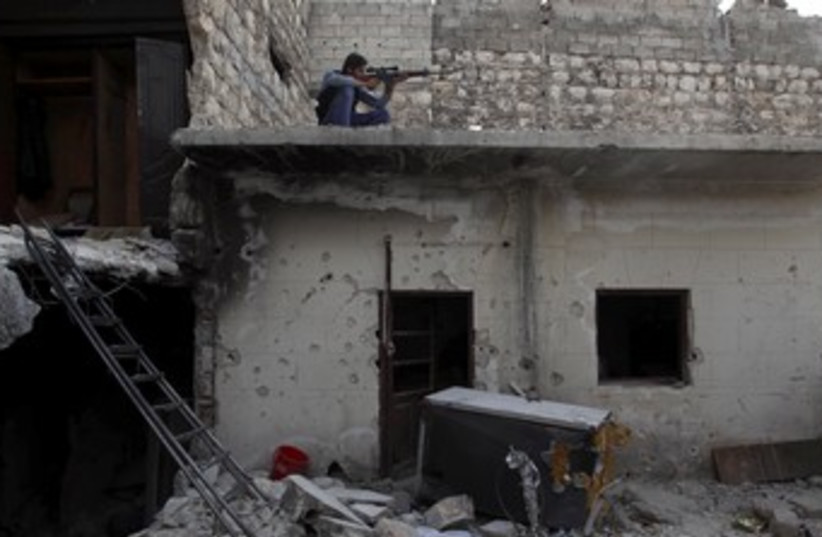 syrian rebel fighter on roof 370 (photo credit: REUTERS)