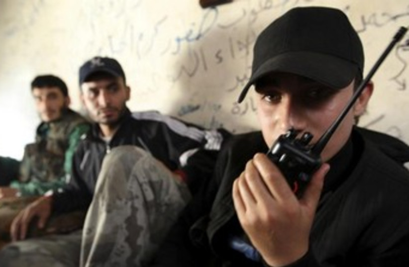 Syrian Rebels on the radio 370 (photo credit: REUTERS)