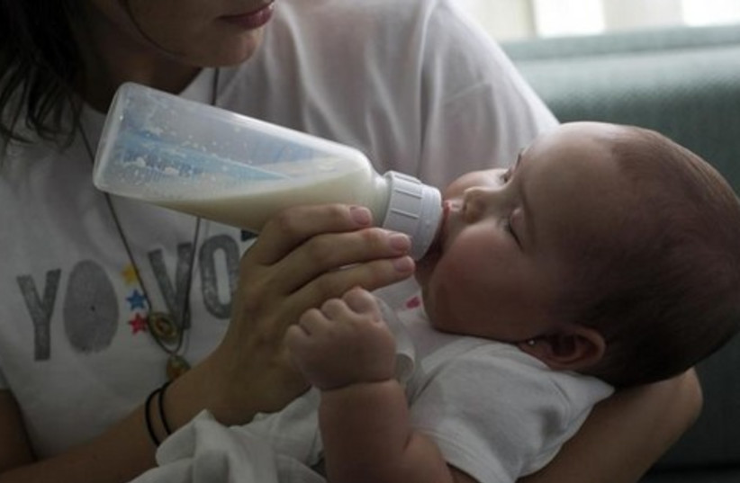 baby drinking from bottle 521 (photo credit: Reuters)