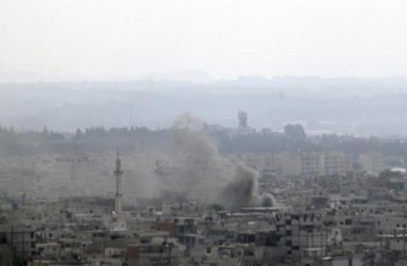 Smoke rises in Latakia 370 (photo credit: REUTERS)