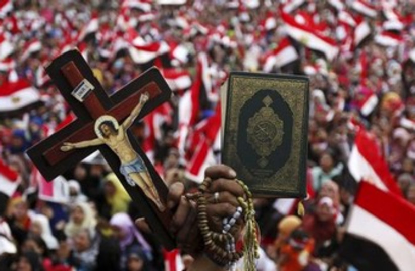 Christian and Muslim in Tahrir370 (photo credit: Reuters)