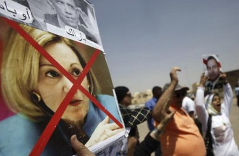 Supporters of deposed president Morsi with defaced photo of US Ambassador to Egypt Anne Patterson. 