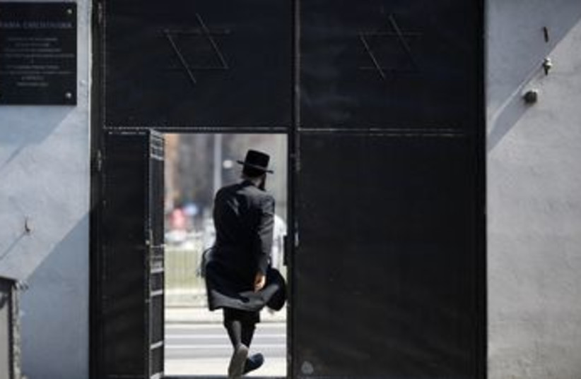 Haredi man leaves the Jewish Cemetery in Warsaw 370 (photo credit: REUTERS/Kacper Pempel)