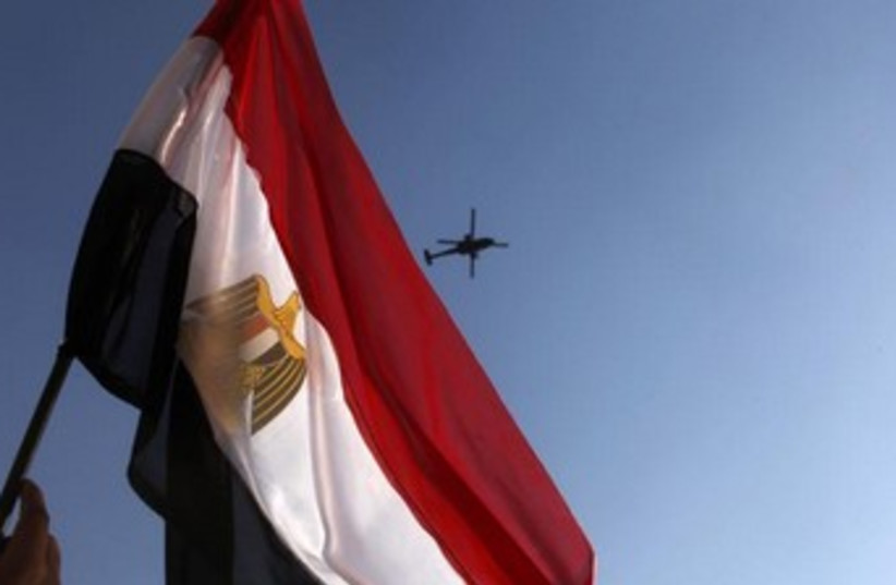 Egypt flag waving with helicopter in background 370 (photo credit: REUTERS/Asmaa Waguih)