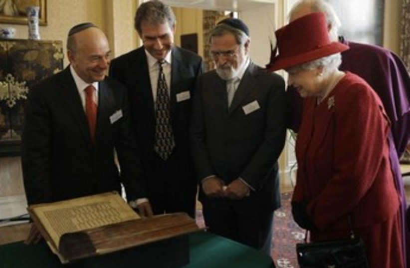 Britain's Queen Elizabeth is shown the Codex Valmadonna book (photo credit: REUTERS)