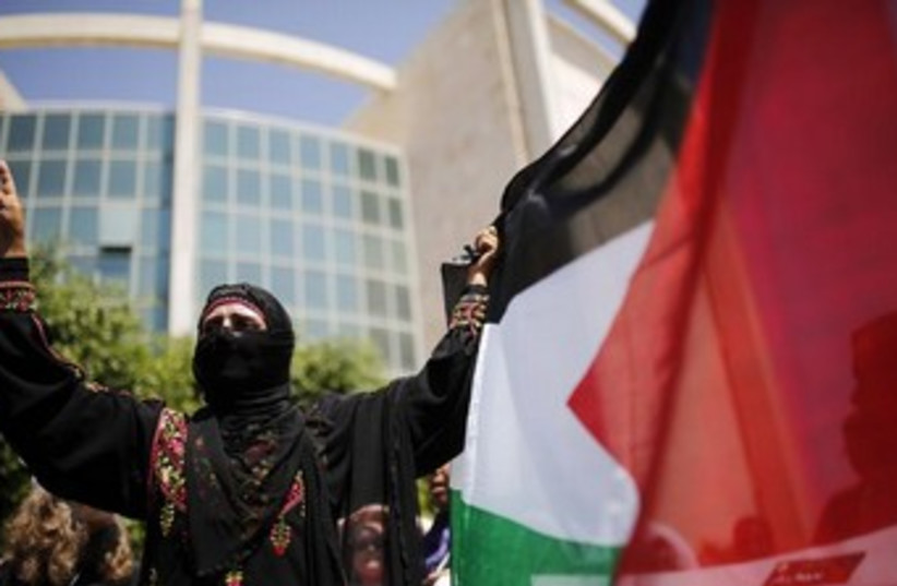 Palestinian woman with flag 370 (photo credit: REUTERS/Ammar Awad)