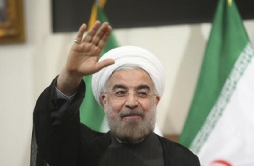 Hassan Rouhani Iran flag in background 370 (photo credit: REUTERS/Raheb Homavandi)