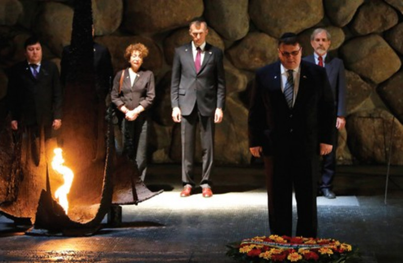 Lithuanian Foreign Minister Linas Linkevicius lays a wreath  (photo credit: AMMAR AWAD / REUTERS)