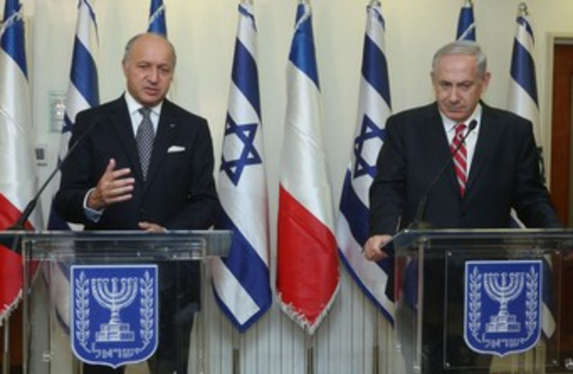 French Foreign Minister Laurent Fabius meets with bib 370 (photo credit: Marc Israel Sellem/The Jerusalem Post)