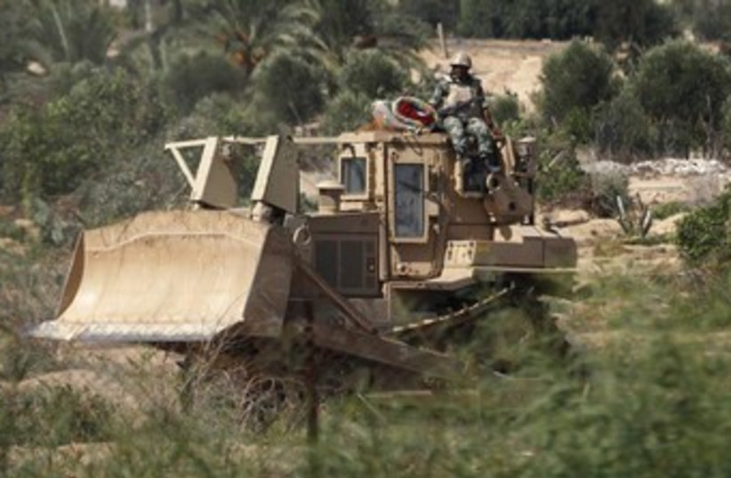 Egyptian soldier sits on a bulldozer near Rafah 370 (photo credit: REUTERS)